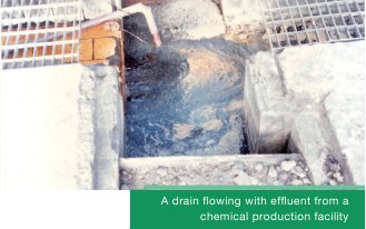 A drain flowing with effluent from a chemical production facility