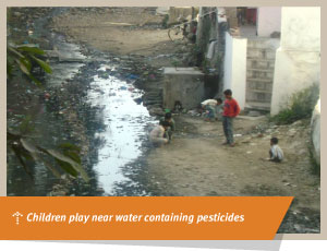 Children play near water containing pesticides